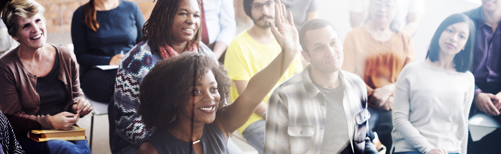 students in class raising hands