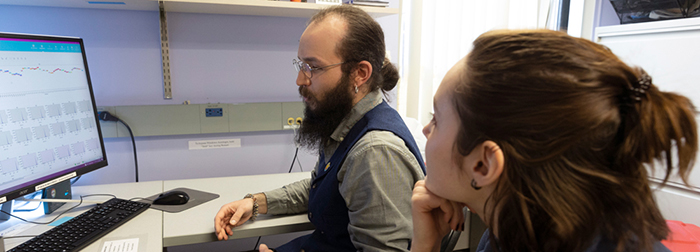 Steve and Daria looking at a computer monitor