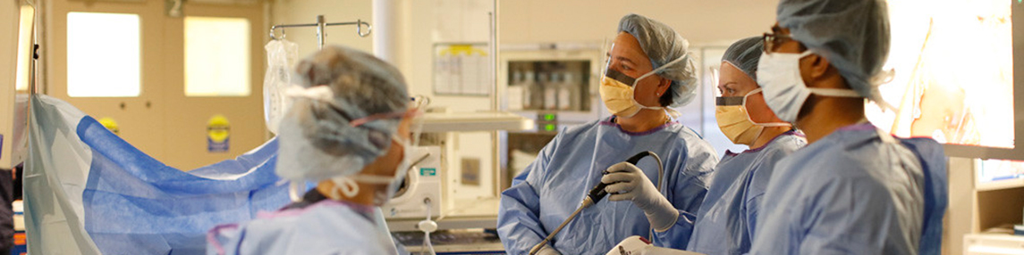 Doctor Performing Surgery and Teaching Students in the Process