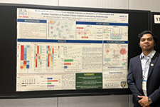 M.D. Mahmudul Hasan Akash Standing Next to His Poster