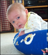 Baby leaning on pillow